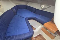 Interior cabin of 2007 Cranchi CSL 27 with blue seating and wooden accents.