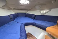 2007 Cranchi CSL 27 cabin interior with blue upholstery and wooden accents.