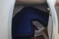 Interior cabin of 2007 Cranchi CSL 27 boat with blue seating and wooden flooring.