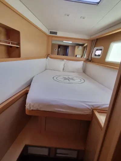 Fellowship Yacht Photos Pics Interior cabin of 2017 Lagoon 450 F catamaran with cozy bed and wooden finish.