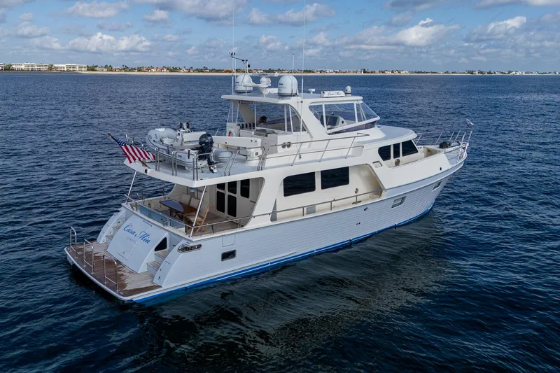 Cara Mia Yacht Photos Pics 2021 Marlow 53E Explorer yacht cruising on open water under a partly cloudy sky.