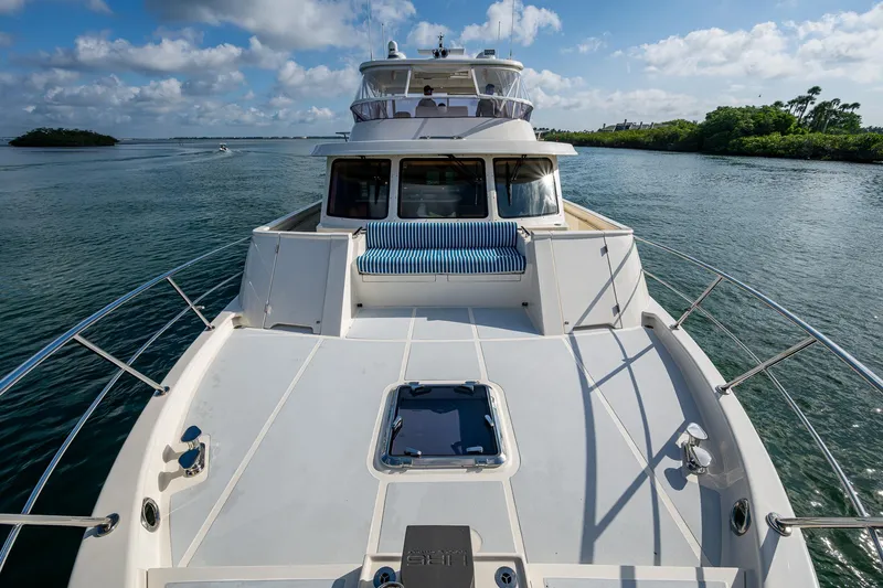 Cara Mia Yacht Photos Pics 2021 Marlow 53E Explorer yacht on serene waterway under blue sky.