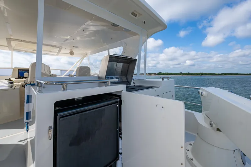 Cara Mia Yacht Photos Pics Luxury Marlow 53E Explorer yacht deck with open fridge, 2021 model, scenic water view.