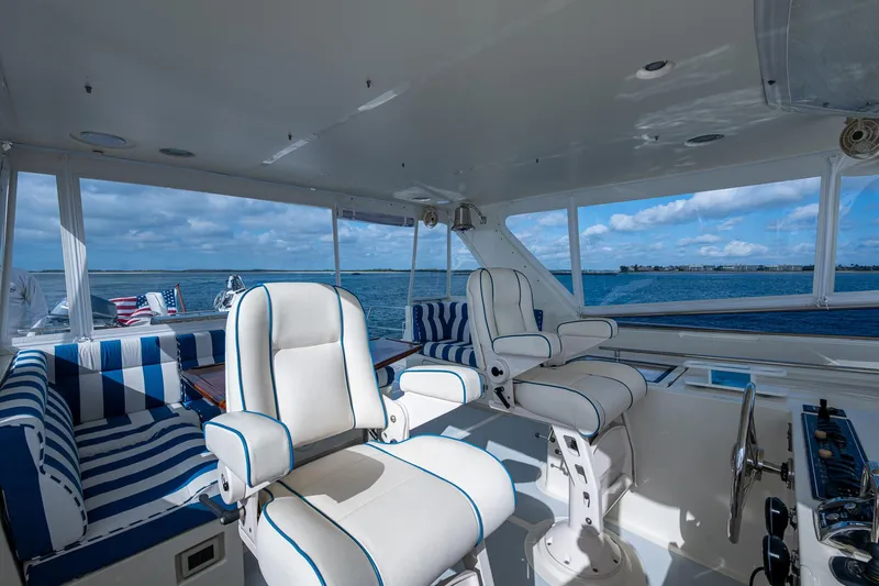 Cara Mia Yacht Photos Pics Luxurious interior of 2021 Marlow 53E Explorer yacht with striped seating and ocean view.