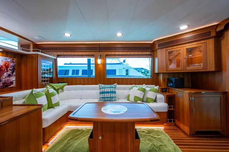 Cara Mia Yacht Photos Pics Luxurious interior of 2021 Marlow 53E Explorer yacht with elegant wood finish and plush seating.