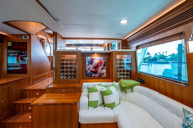 Cara Mia Yacht Photos Pics Luxurious interior of 2021 Marlow 53E Explorer yacht with elegant wood finish and plush seating.