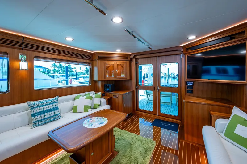 Cara Mia Yacht Photos Pics Luxurious interior of 2021 Marlow 53E Explorer yacht with elegant wood finishes and plush seating.