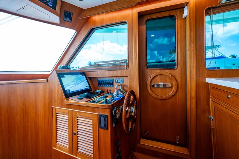 Cara Mia Yacht Photos Pics Interior of 2021 Marlow 53E Explorer yacht with wooden helm and navigation equipment.