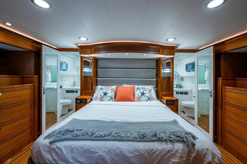 Cara Mia Yacht Photos Pics Luxurious bedroom in 2021 Marlow 53E Explorer yacht with elegant wood finishes.