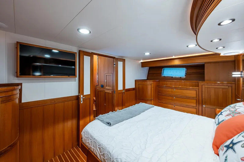 Cara Mia Yacht Photos Pics Luxurious cabin interior of 2021 Marlow 53E Explorer yacht with wood paneling and modern amenities.