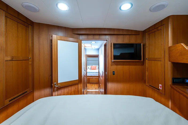 Cara Mia Yacht Photos Pics Luxurious cabin interior of 2021 Marlow 53E Explorer yacht with wood paneling and modern amenities.