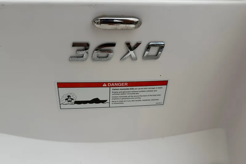 Monet Yacht Photos Pics 2021 Regal 36 XO boat model emblem with safety warning label.