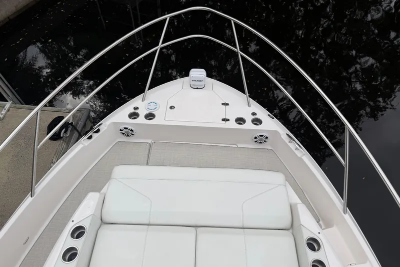 Monet Yacht Photos Pics 2021 Regal 36 XO boat deck with seating and railing, docked by water.