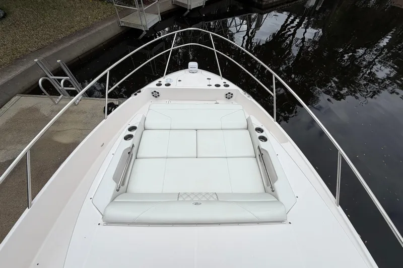 Monet Yacht Photos Pics 2021 Regal 36 XO boat with spacious white deck seating by the water.