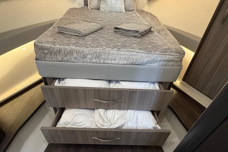 Monet Yacht Photos Pics 2021 Regal 36 XO cabin with bed, storage drawers, and modern interior design.