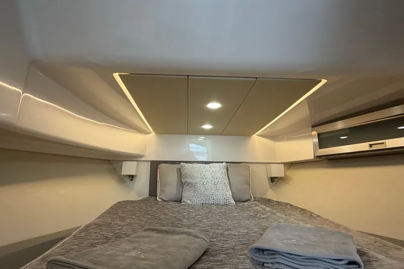 Monet Yacht Photos Pics Luxurious cabin interior of 2021 Regal 36 XO yacht with modern bedding and ambient lighting.