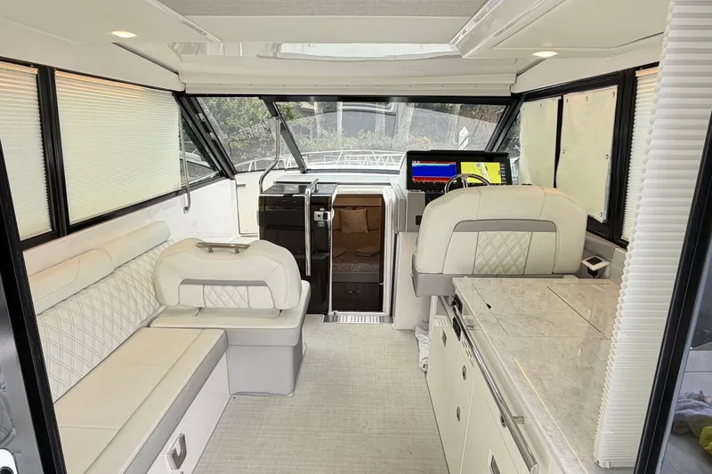 Monet Yacht Photos Pics 2021 Regal 36 XO yacht interior with luxurious seating and modern navigation system.