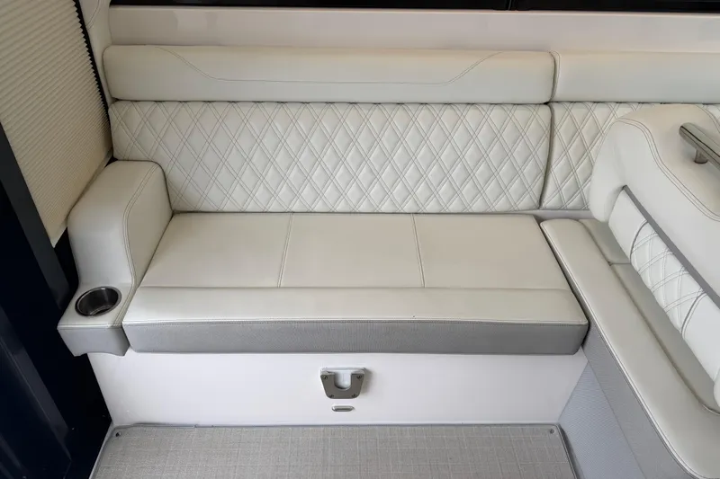 Monet Yacht Photos Pics Luxurious seating on 2021 Regal 36 XO boat with diamond-stitched upholstery and cup holder.