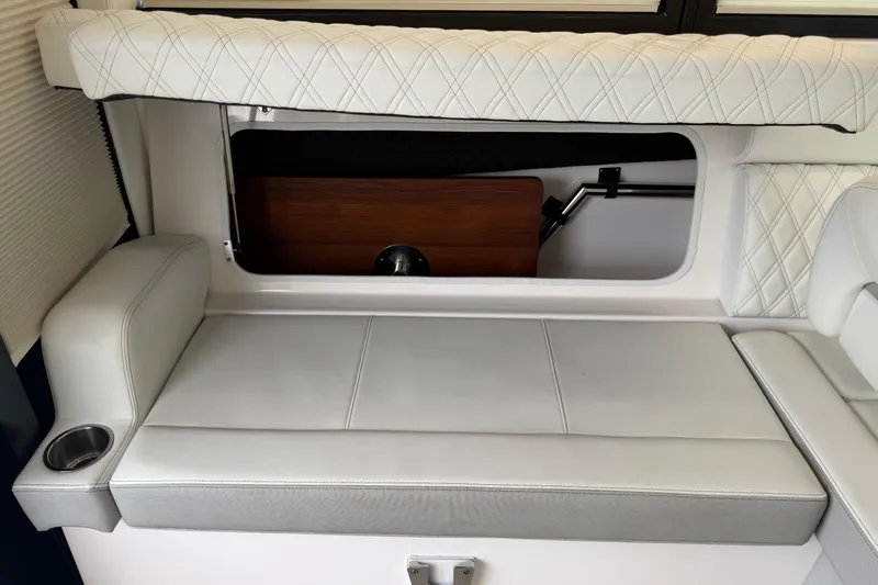 Monet Yacht Photos Pics 2021 Regal 36 XO boat interior with white cushioned seating and cup holder.