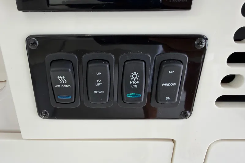 Monet Yacht Photos Pics Control panel of a 2021 Regal 36 XO boat with air conditioning and lighting switches.