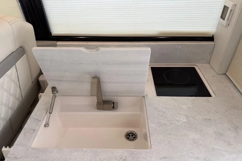 Monet Yacht Photos Pics Modern kitchen area in 2021 Regal 36 XO yacht with sink and induction cooktop.