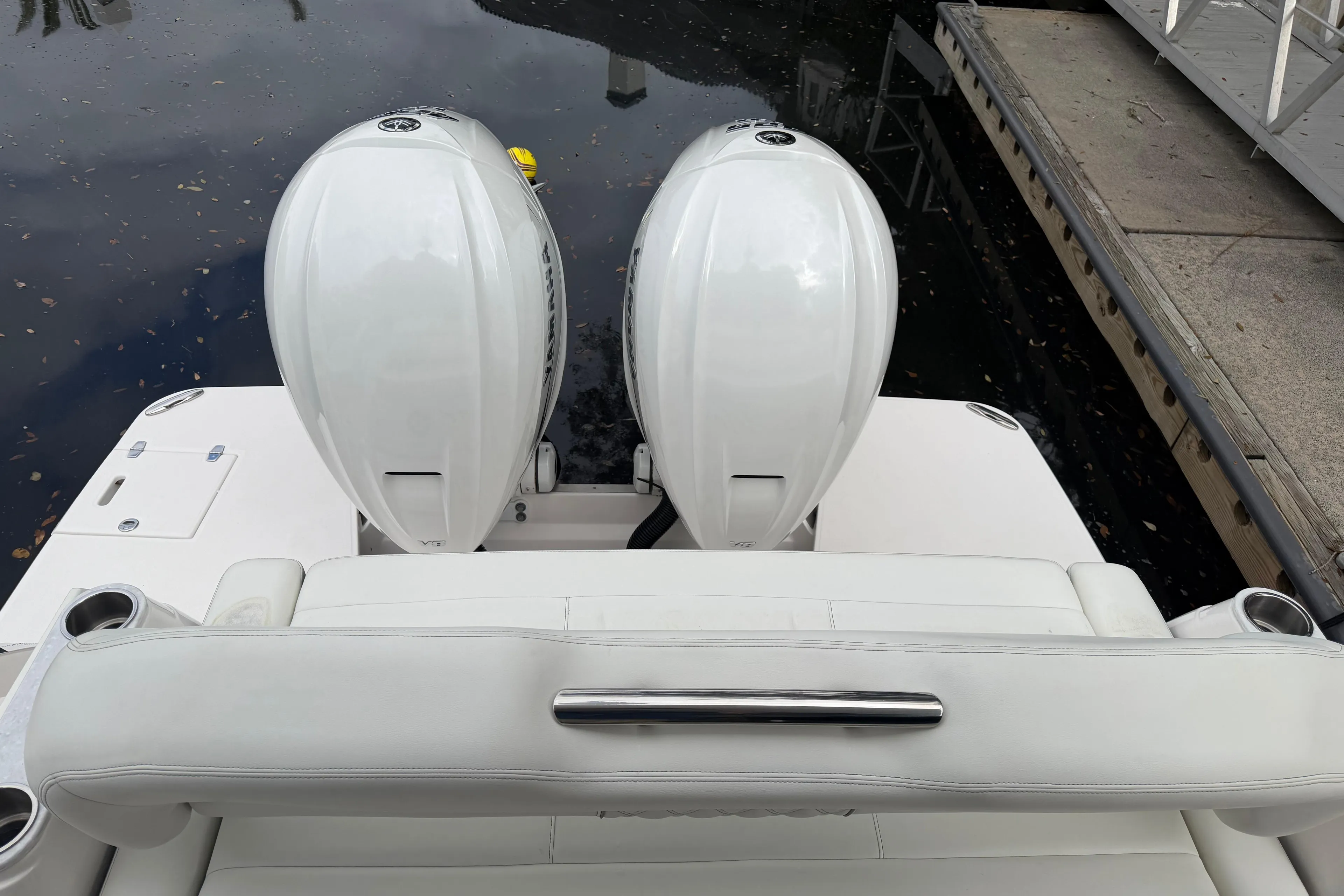 2021 Regal 36 XO boat with dual outboard engines at dockside.