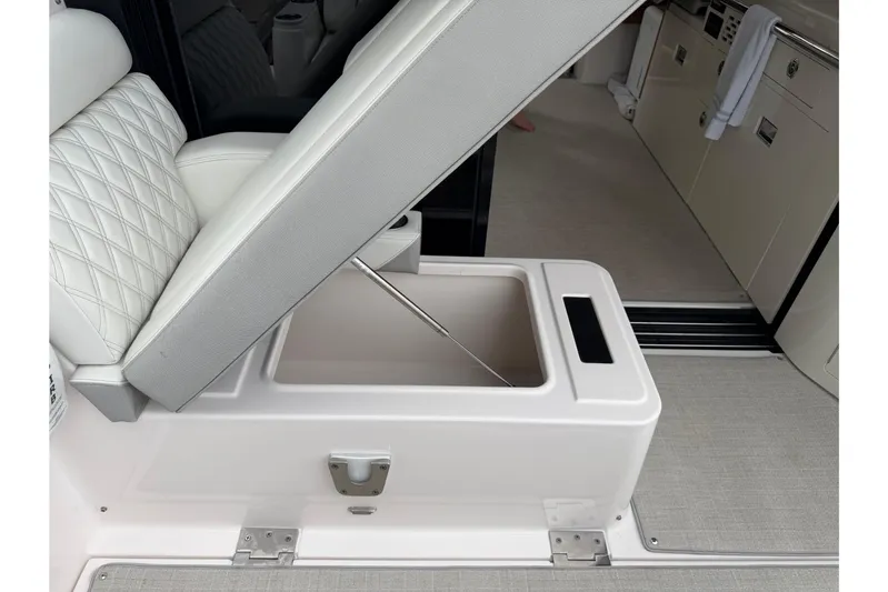 Monet Yacht Photos Pics 2021 Regal 36 XO boat interior with open storage compartment under cushioned seat.
