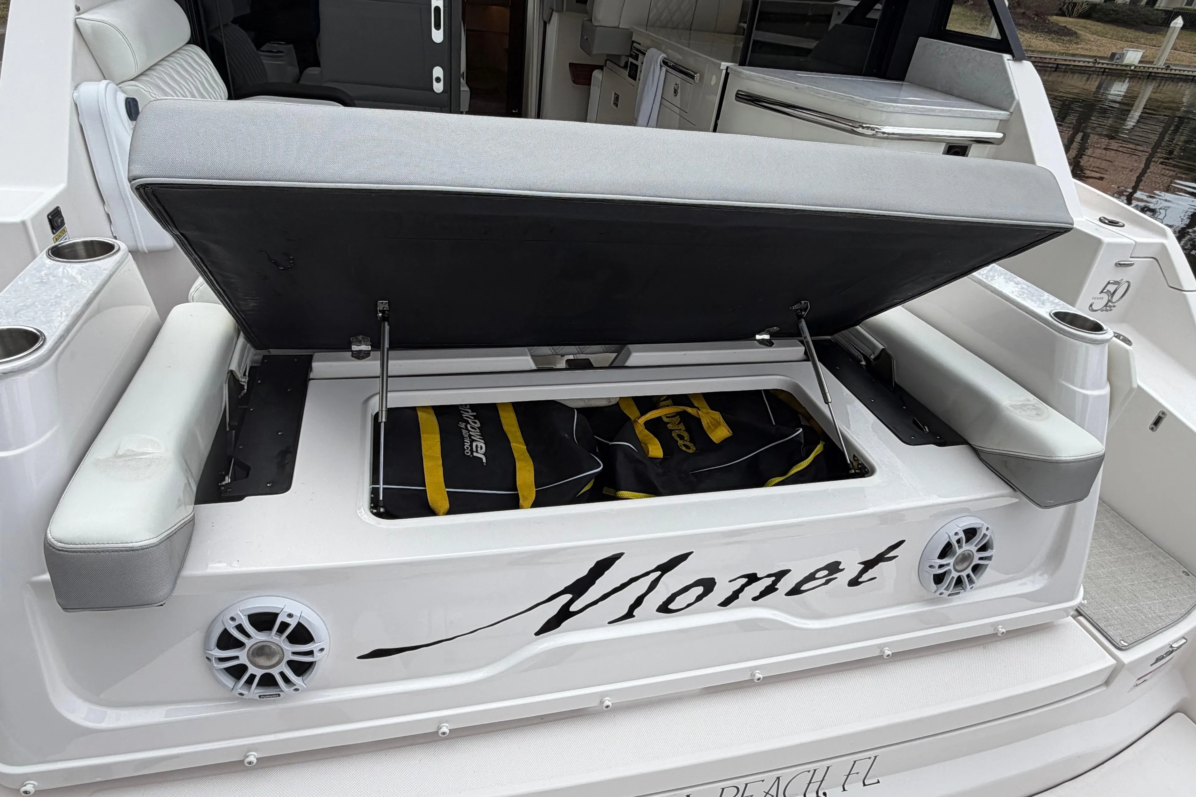 2021 Regal 36 XO boat with open storage compartment and seating area.