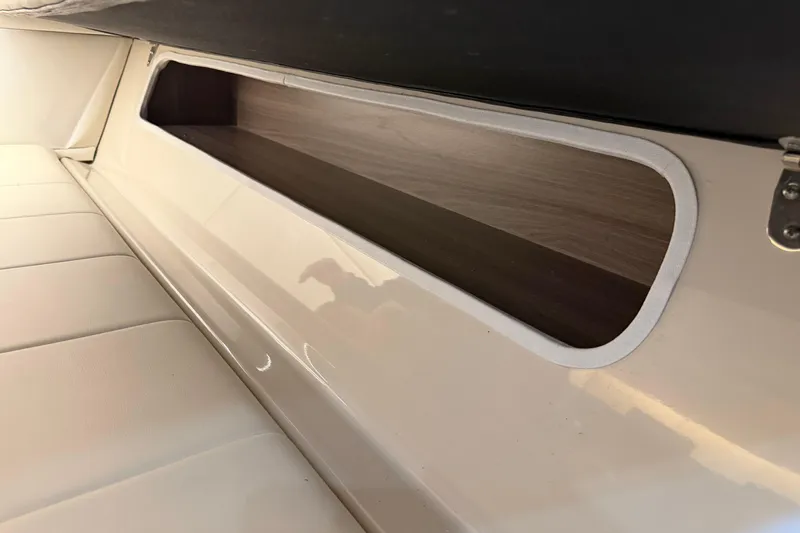 Monet Yacht Photos Pics Interior storage compartment of 2021 Regal 36 XO boat, featuring sleek design and wood finish.