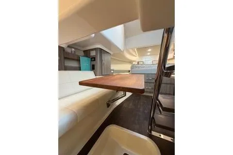 Monet Yacht Photos Pics 2021 Regal 36 XO yacht interior with modern seating and wooden table.