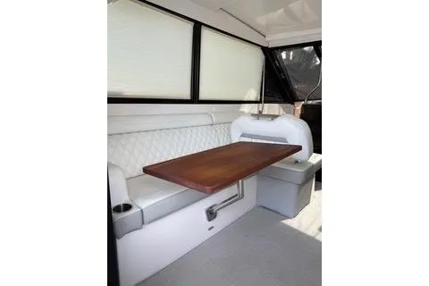 Monet Yacht Photos Pics 2021 Regal 36 XO yacht interior with elegant seating and wooden table.