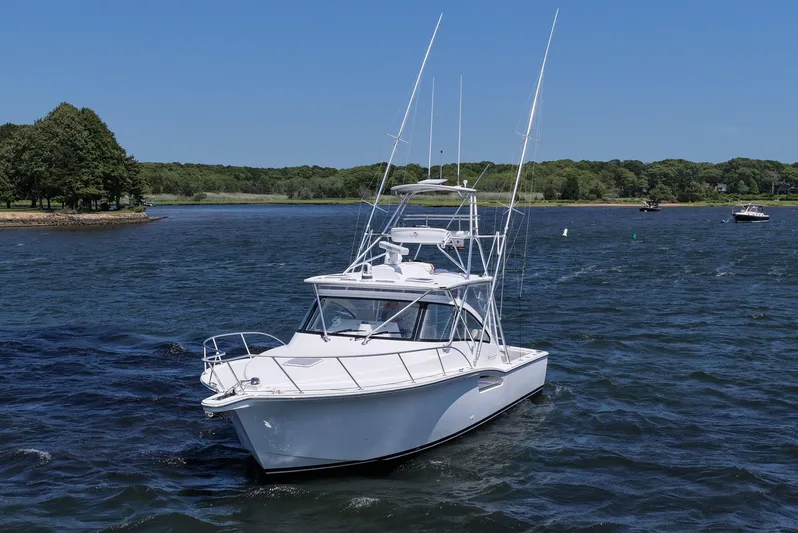 Salty Bear Yacht Photos Pics 2022 Albemarle 360 Express Fisherman boat on a scenic lake with trees in the background.