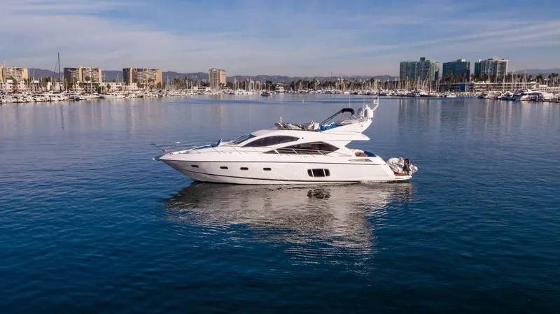  Yacht Photos Pics 2010 Sunseeker Manhattan 60 yacht on calm water with cityscape background.