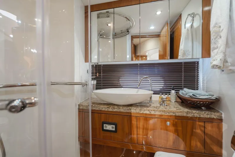  Yacht Photos Pics Luxurious bathroom in 2010 Sunseeker Manhattan 60 yacht with modern sink and elegant wood finish.