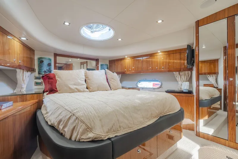  Yacht Photos Pics Luxurious bedroom interior of 2010 Sunseeker Manhattan 60 yacht with elegant wood finishes.