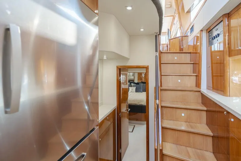  Yacht Photos Pics Interior of 2010 Sunseeker Manhattan 60 yacht, featuring wooden stairs and modern design.