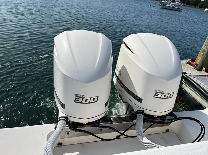 American Made Yacht Photos Pics Twin Yamaha 300 outboard engines on a 2013 Jupiter 30 FS boat, docked by the water.