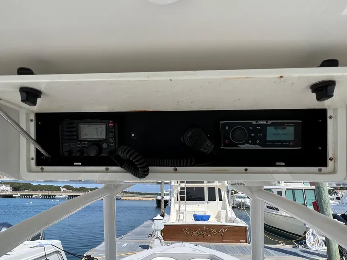American Made Yacht Photos Pics 2013 Jupiter 30 FS boat console with radio and navigation equipment, docked at marina.