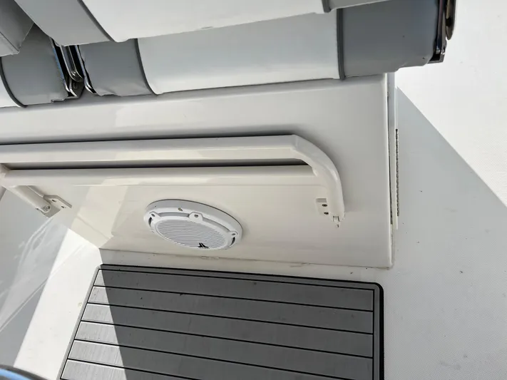 American Made Yacht Photos Pics Interior view of a 2013 Jupiter 30 FS boat, featuring seating and a speaker.