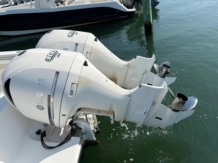 American Made Yacht Photos Pics Twin Yamaha outboard engines on a 2013 Jupiter 30 FS boat, docked in calm waters.
