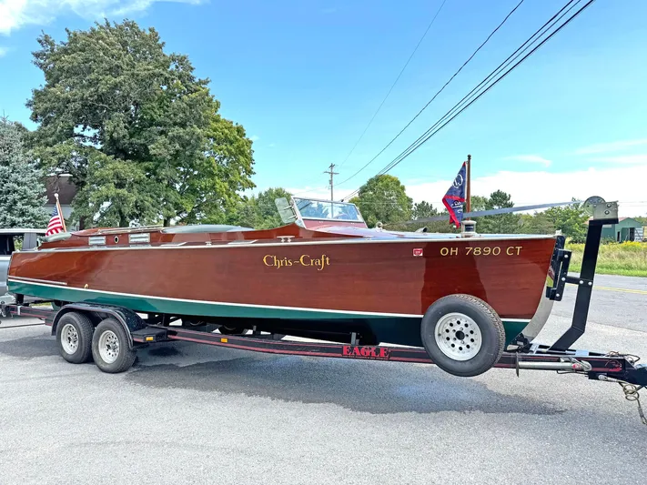 The Paragon Yacht Photos Pics 1929 Chris-Craft 26 Upswept Triple Cockpit boat on trailer, parked outdoors.