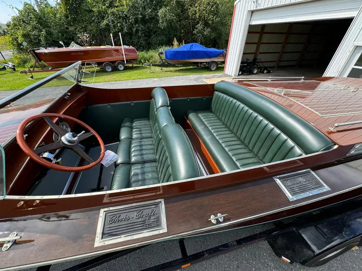 The Paragon Yacht Photos Pics 1929 Chris-Craft 26 Upswept Triple Cockpit with green leather seats and wooden finish.