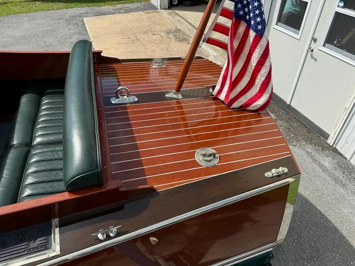 The Paragon Yacht Photos Pics 1929 Chris-Craft 26 Upswept Triple Cockpit boat with American flag and polished wood finish.