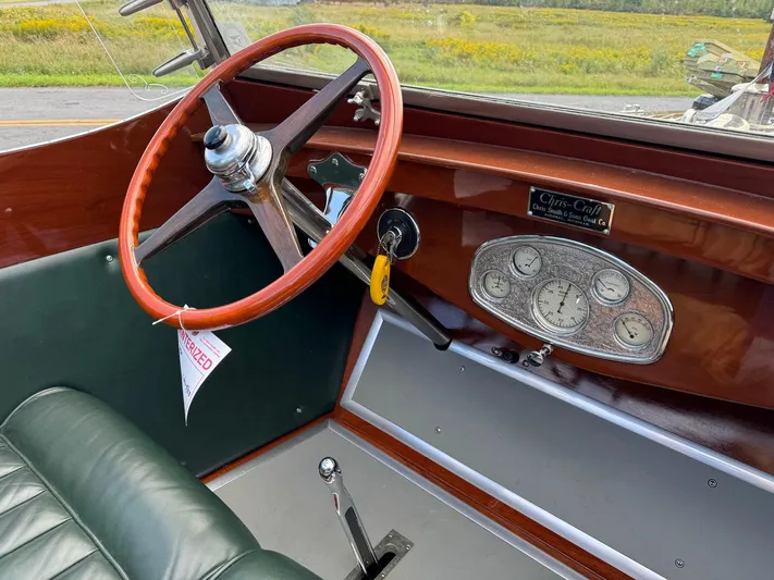 The Paragon Yacht Photos Pics 1929 Chris-Craft 26 Upswept Triple Cockpit interior with vintage steering wheel and dashboard.