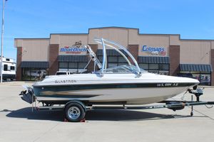 2001 Glastron GX 185 boat on trailer outside dealership.