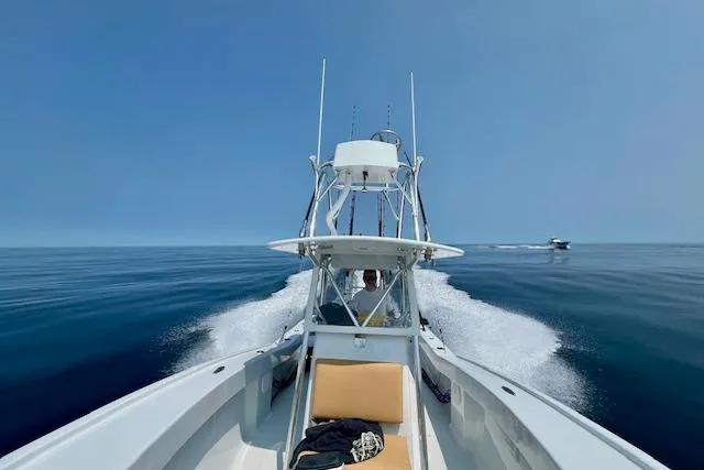  Yacht Photos Pics Custom Carolina Forbes 2025 boat cruising on calm blue ocean under clear sky.