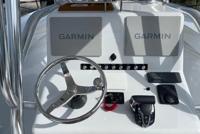  Yacht Photos Pics 2025 Custom Carolina Forbes boat dashboard with dual Garmin displays and steering wheel.