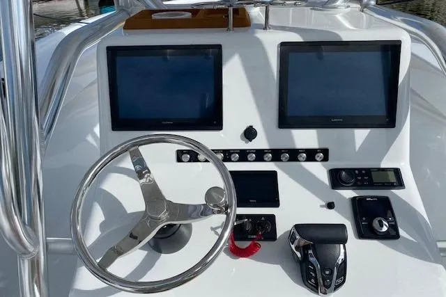  Yacht Photos Pics Control panel of 2025 Custom Carolina Forbes boat with dual screens and steering wheel.
