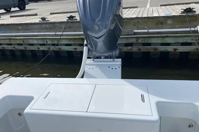  Yacht Photos Pics 2025 Custom Carolina Forbes boat with outboard motor docked at a marina.