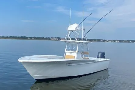  Yacht Photos Pics Custom Carolina Forbes 2025 boat on calm water with fishing rods and clear sky.